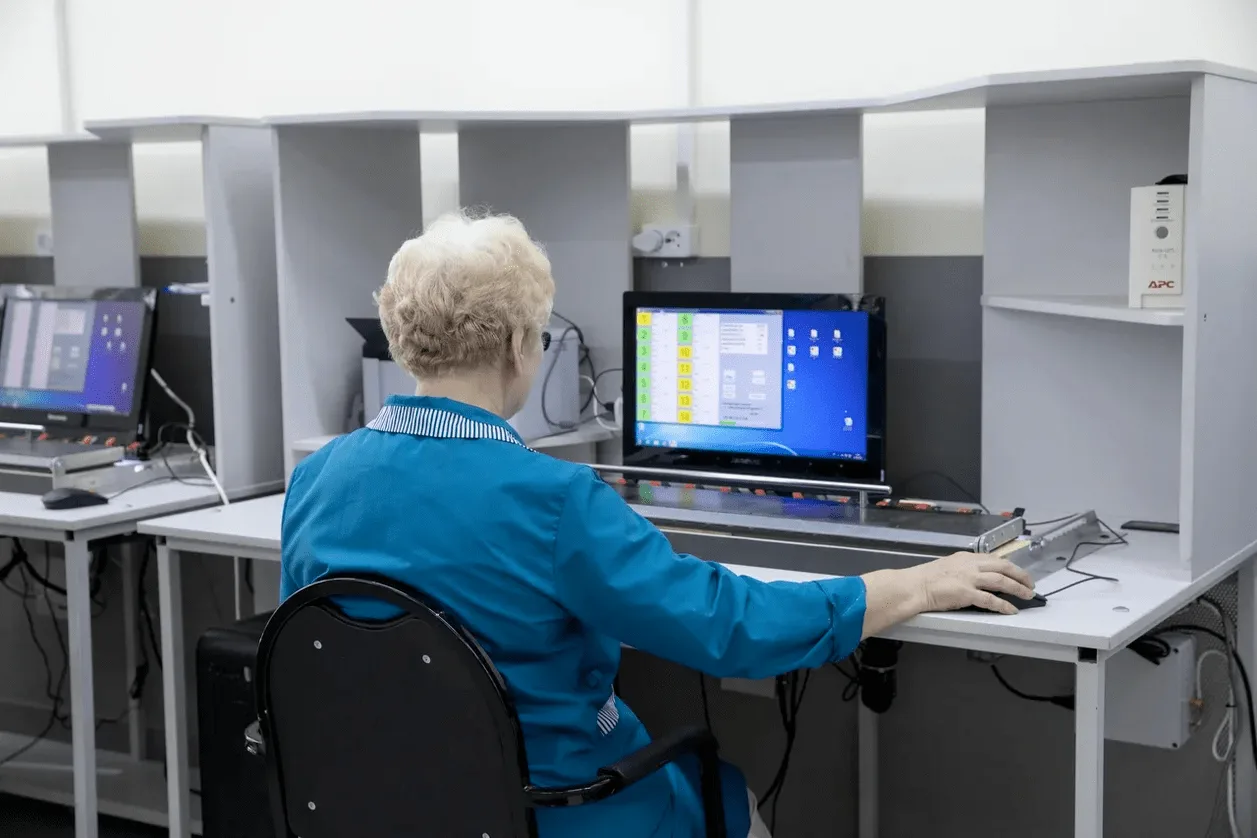 Quality control specialist at computer workstation